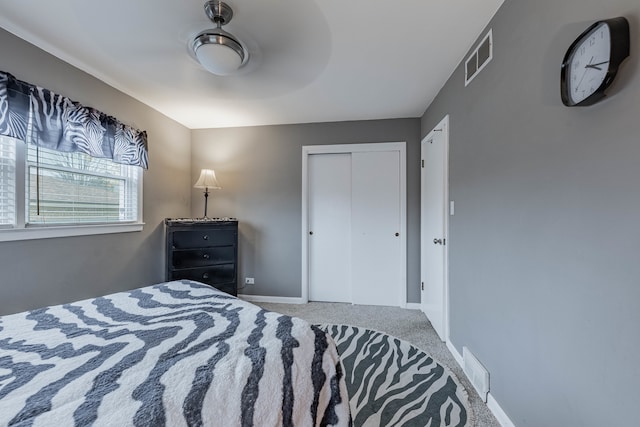 bedroom featuring ceiling fan, a closet, and carpet floors