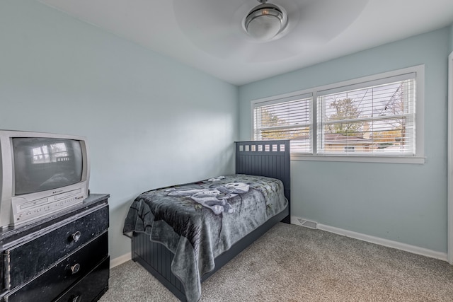 bedroom with carpet floors, multiple windows, and ceiling fan