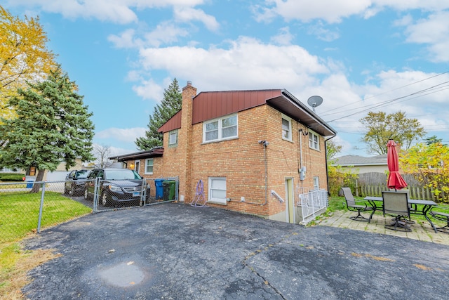 view of side of property with a patio area