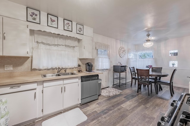 kitchen with sink, stainless steel appliances, tasteful backsplash, wood-type flooring, and white cabinets