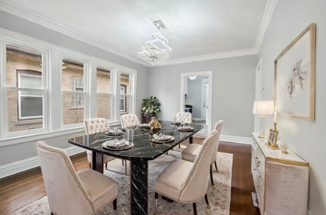 dining area featuring crown molding, dark hardwood / wood-style flooring, and a notable chandelier