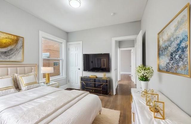 bedroom with dark hardwood / wood-style floors