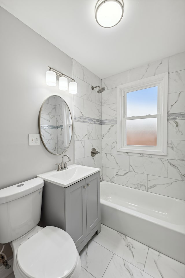 full bathroom featuring tiled shower / bath combo, toilet, and vanity