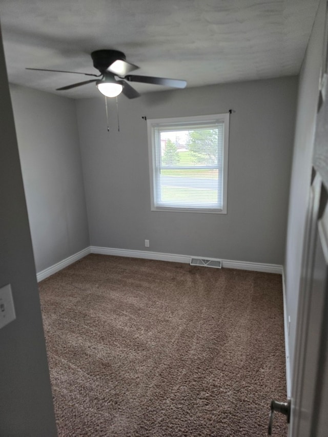 spare room with carpet flooring, a textured ceiling, and ceiling fan