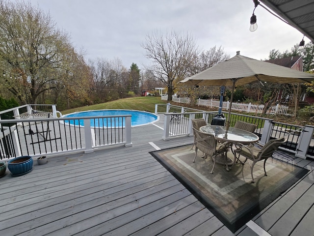 wooden terrace featuring a lawn