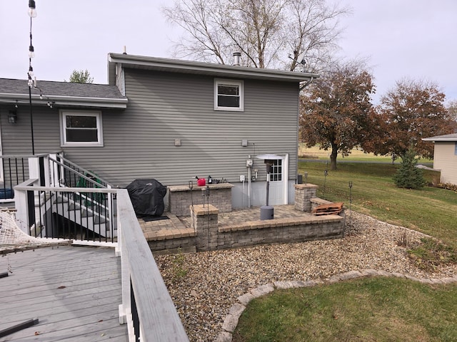 back of property with a lawn and a deck