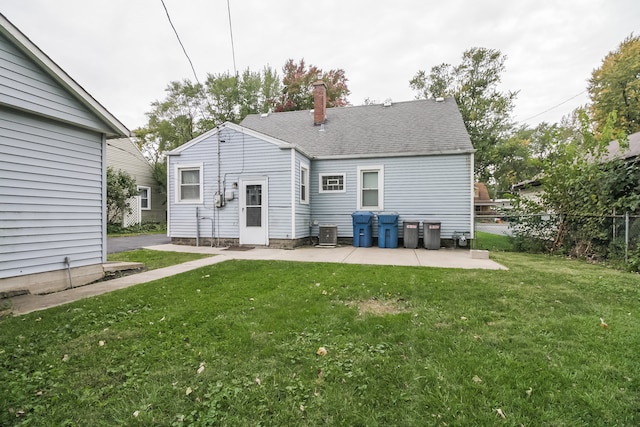 back of house with a patio, central air condition unit, and a lawn