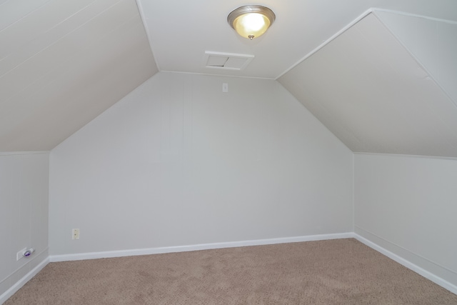 bonus room featuring lofted ceiling and carpet floors