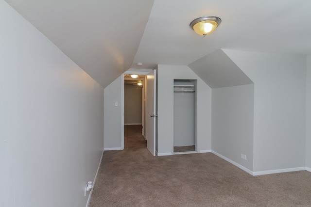 bonus room featuring light carpet and vaulted ceiling