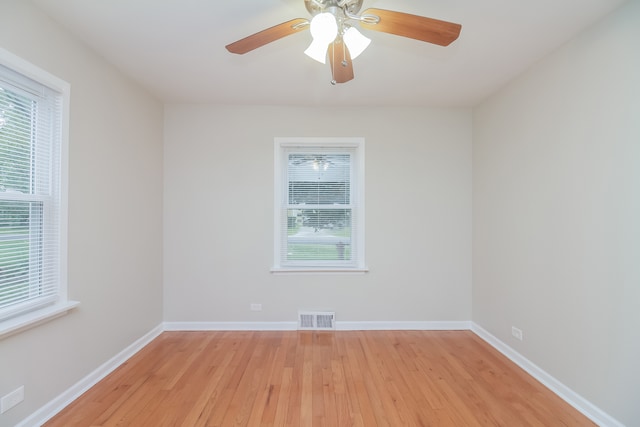 spare room featuring light hardwood / wood-style flooring, plenty of natural light, and ceiling fan