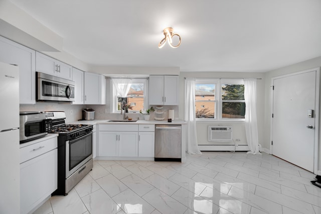 kitchen featuring white cabinets, plenty of natural light, sink, and stainless steel appliances