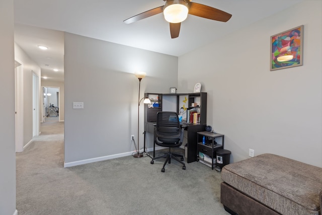 carpeted home office featuring ceiling fan