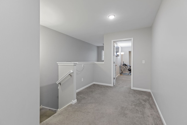 hallway with light colored carpet