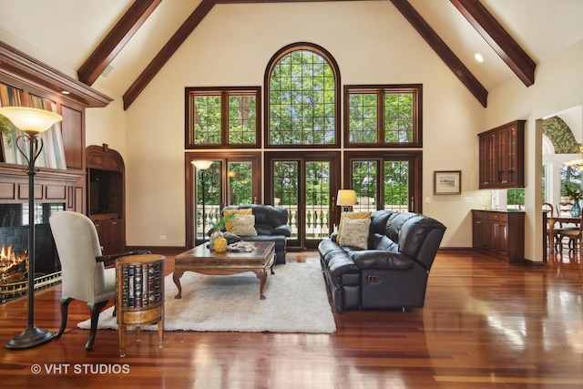 living room featuring beamed ceiling, dark hardwood / wood-style flooring, and high vaulted ceiling