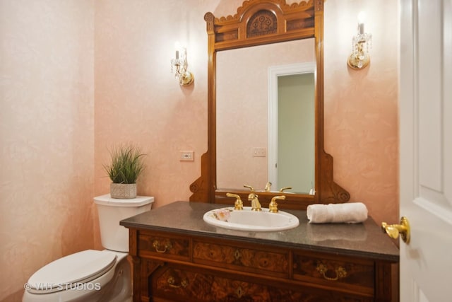 bathroom with toilet and vanity