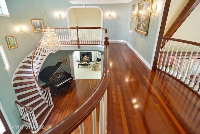 hallway featuring hardwood / wood-style flooring and an inviting chandelier