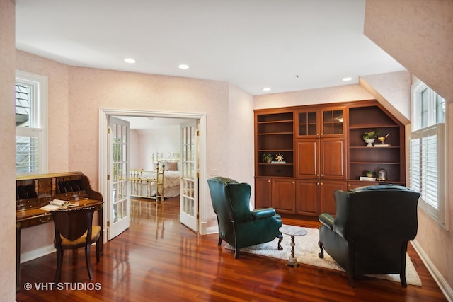 sitting room with built in features, french doors, and dark hardwood / wood-style floors