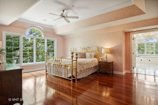 bedroom featuring ceiling fan, wood-type flooring, a tray ceiling, and ornamental molding