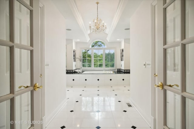 interior space with tile patterned flooring, ornamental molding, and a tub to relax in