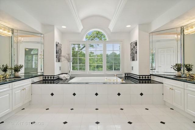 bathroom featuring tiled tub, tile patterned floors, vanity, and a chandelier