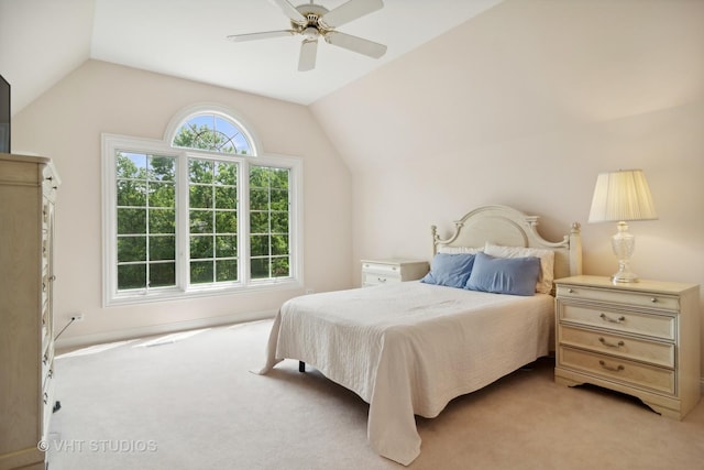 carpeted bedroom with ceiling fan and lofted ceiling