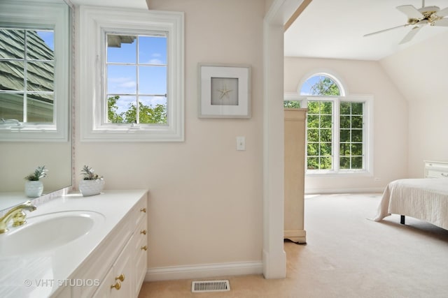 bathroom featuring vaulted ceiling, ceiling fan, and vanity