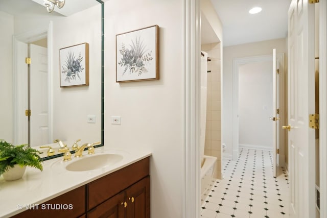 bathroom featuring vanity and tiled shower / bath