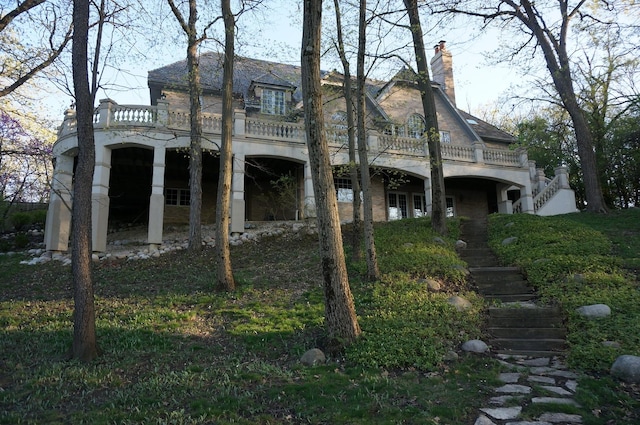 back of house featuring a balcony