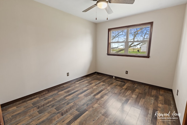 empty room featuring dark hardwood / wood-style floors and ceiling fan