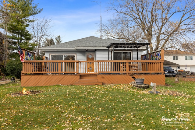 back of house with a lawn and a deck