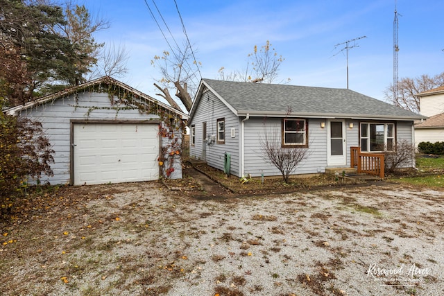 view of front of house with a garage and an outdoor structure