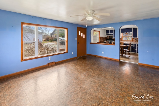 unfurnished living room with ceiling fan