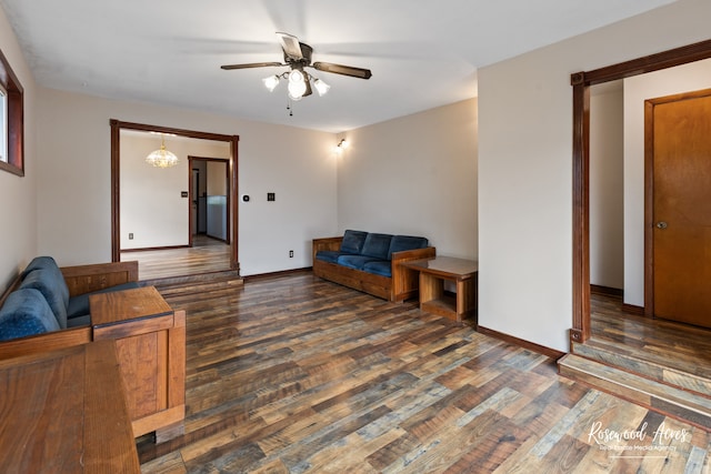 living room featuring ceiling fan and dark hardwood / wood-style floors