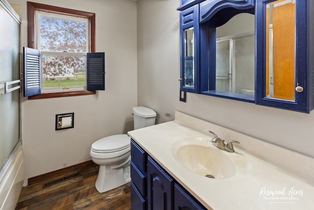 full bathroom with toilet, vanity, enclosed tub / shower combo, and hardwood / wood-style flooring