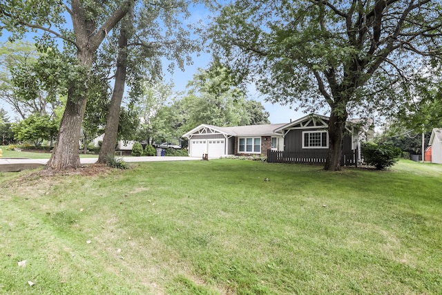 view of front of property with a front yard and a garage