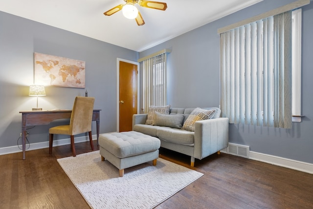 living room with a wealth of natural light, ceiling fan, and dark hardwood / wood-style flooring