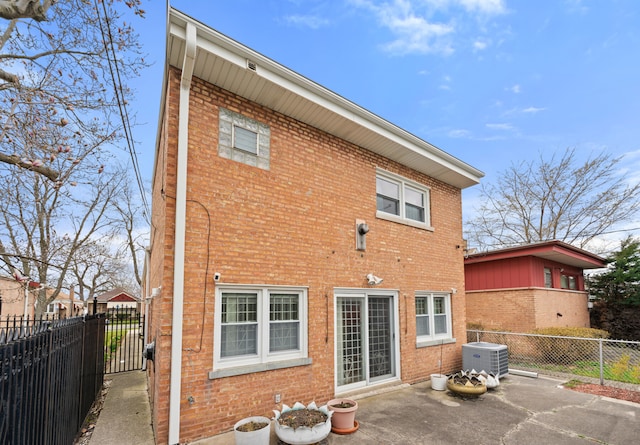 back of house featuring central air condition unit and a patio area