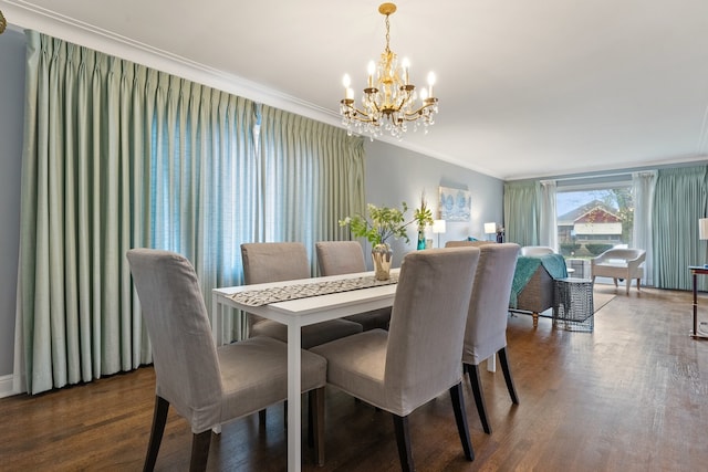 dining room featuring an inviting chandelier, dark wood-type flooring, and ornamental molding