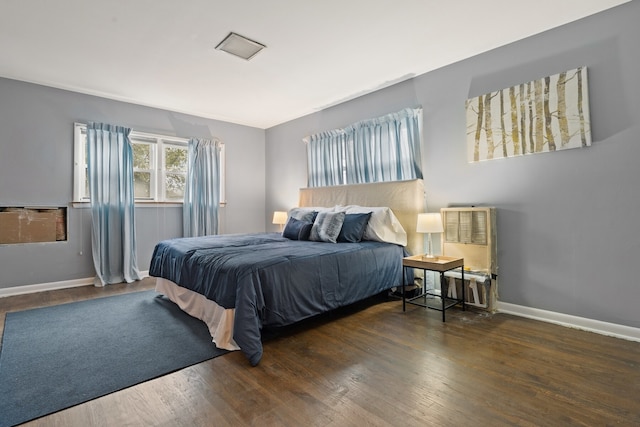 bedroom with dark hardwood / wood-style floors