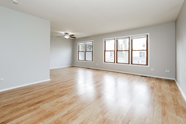 unfurnished room featuring ceiling fan and light hardwood / wood-style floors