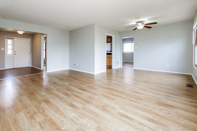 unfurnished living room with ceiling fan and light hardwood / wood-style floors