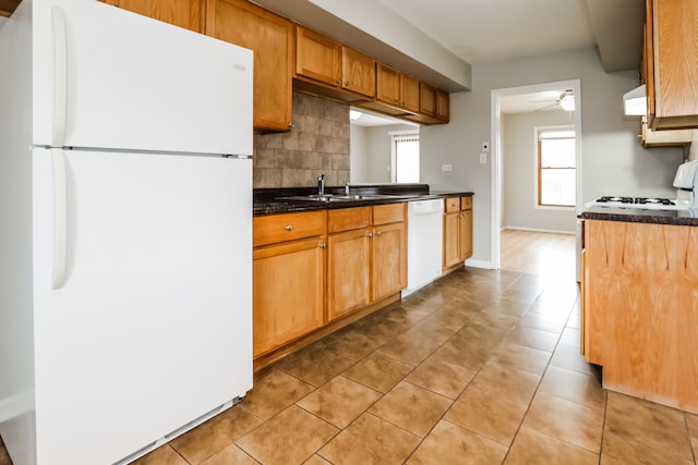 kitchen featuring ceiling fan, sink, white appliances, decorative backsplash, and light tile patterned flooring