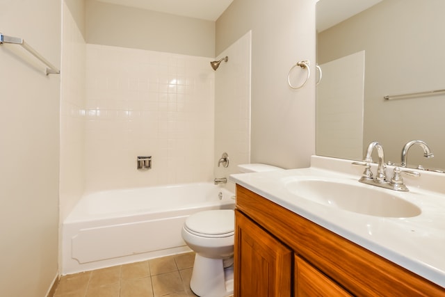 full bathroom with tile patterned floors, tiled shower / bath, vanity, and toilet