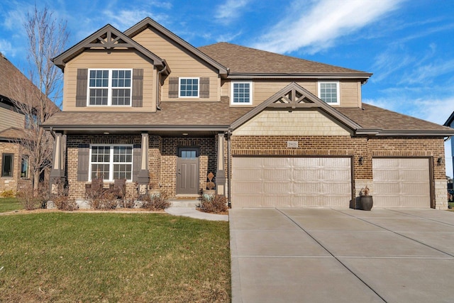 craftsman house with a garage and a front lawn