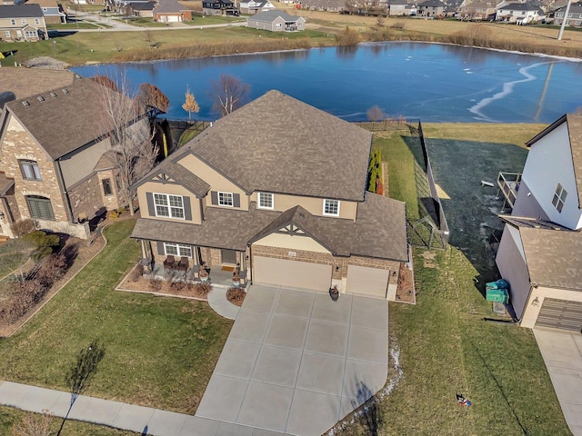 birds eye view of property with a water view