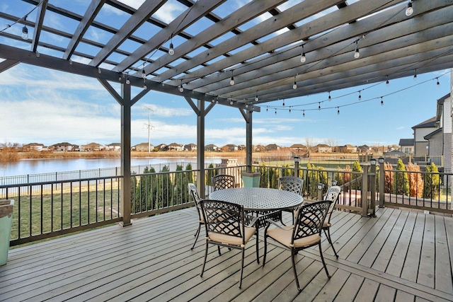 wooden deck with a pergola and a water view