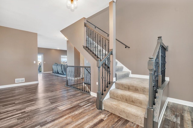 stairway with hardwood / wood-style floors