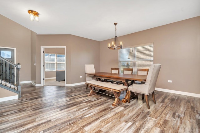 dining room featuring hardwood / wood-style flooring, a wealth of natural light, and an inviting chandelier