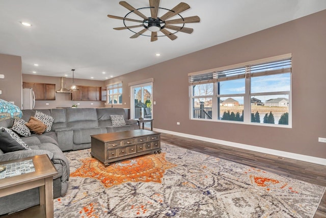 living room with ceiling fan and dark wood-type flooring