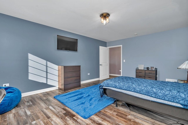 bedroom with hardwood / wood-style flooring